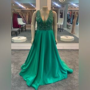 size 24w. jeweled top. deep v cut front. slit. pockets. emerald